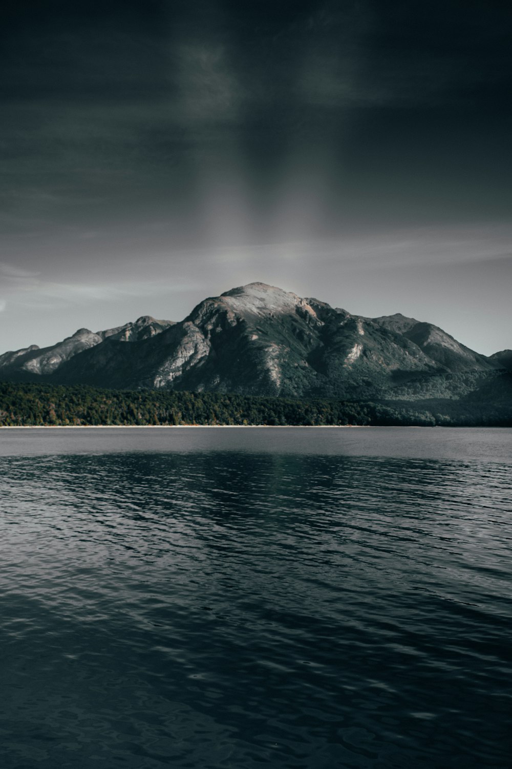 white mountain near body of water