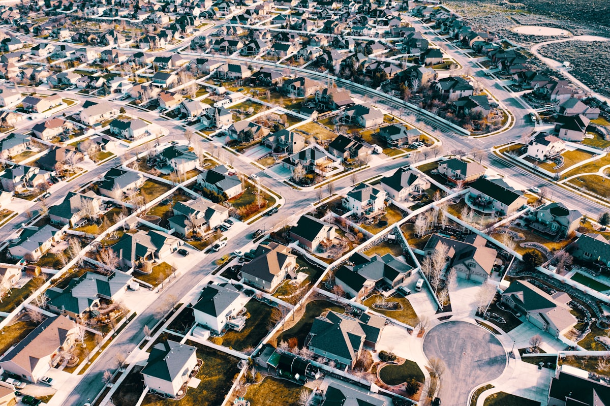 Aerial view of a suburban housing estate with curved streets and rooftops