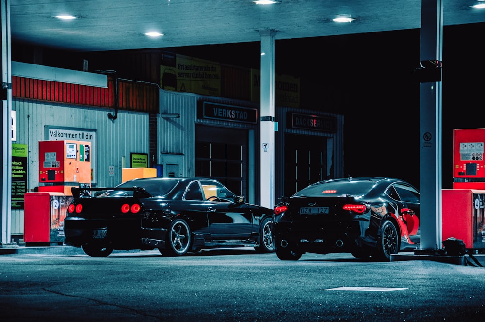 Two black cars parked beside gasoline station.
We have been receiving hundreds of videos where a petrol pump catches fire because someone was using a mobile phone. There are some boards on such fuel stations saying, "Please switch off your phone"
However, most of us ignore that board and probably not even switch off the phone. 
Contrarily, we use PayTM to make payments for our fuel. 
So what is the reality?