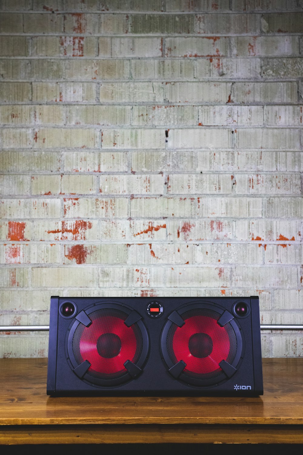 a pair of speakers sitting on top of a wooden table