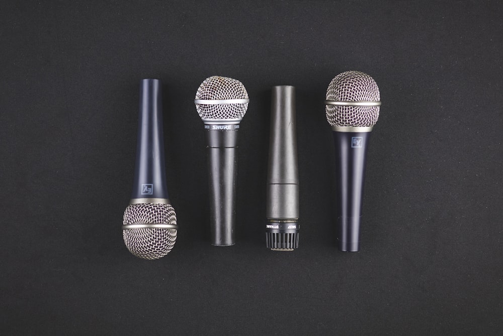 four black microphones