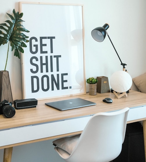 brown and white wooden desk with chair and laptop