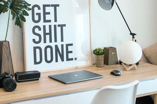 brown and white wooden desk with chair and laptop