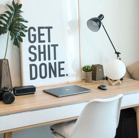 brown and white wooden desk with chair and laptop