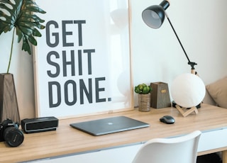 brown and white wooden desk with chair and laptop