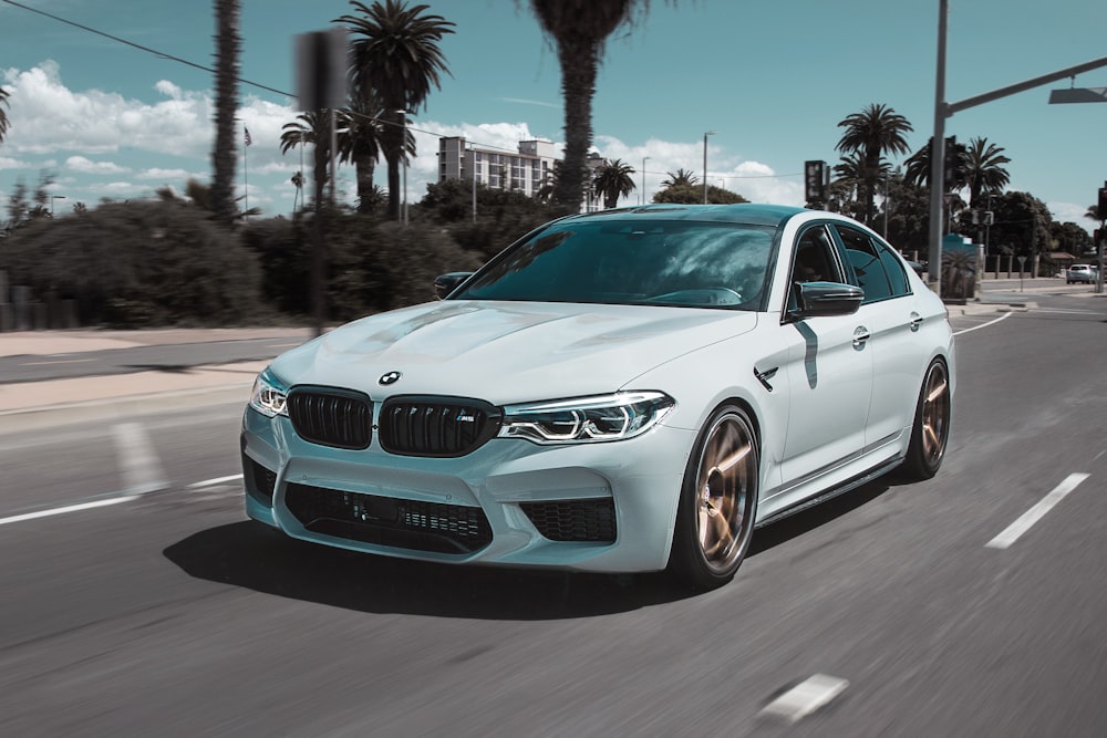 white BMW car on street