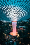 water fountain inside building surrounded with crowd