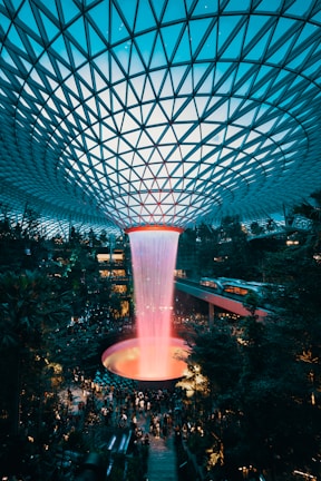 water fountain inside building surrounded with crowd