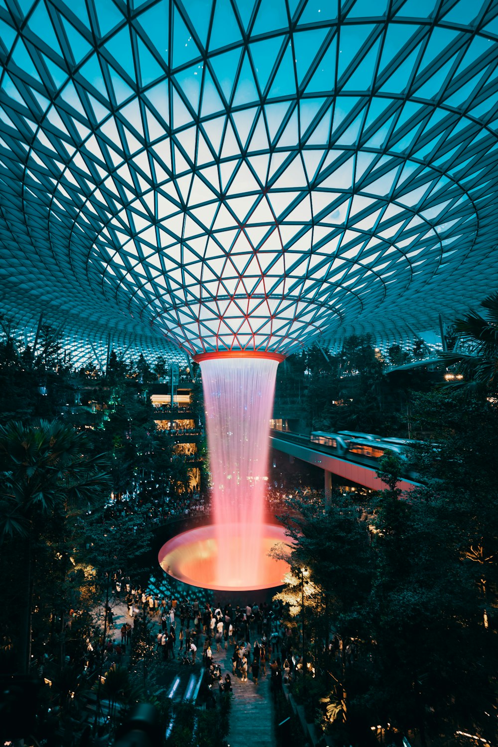 water fountain inside building surrounded with crowd