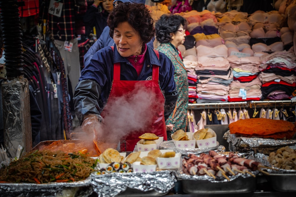 woman standing while wearing red apron