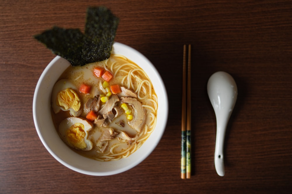 ramen platter beside chopsticks and ladle