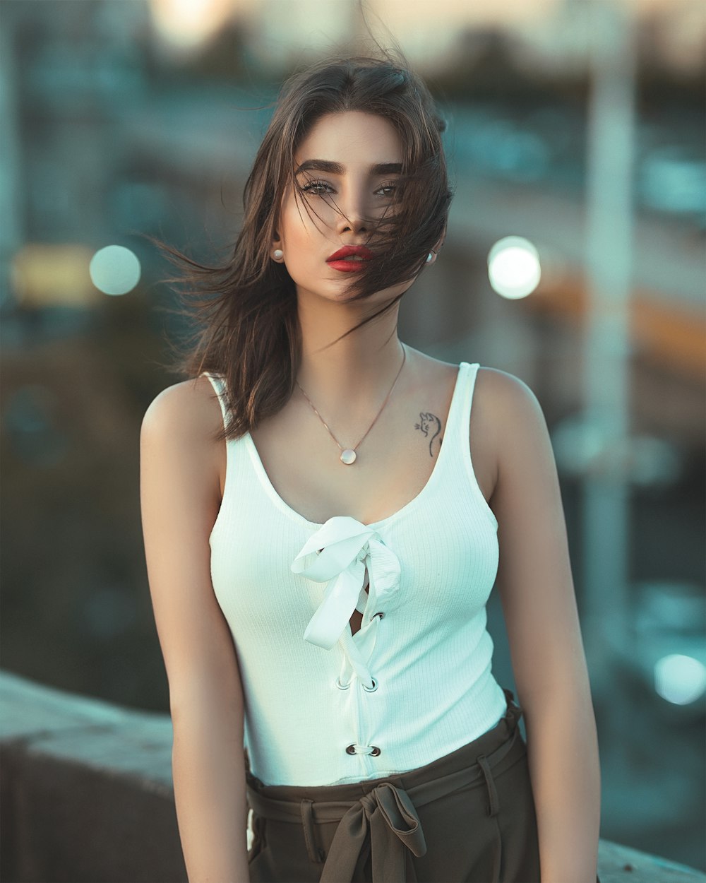 woman wearing black sleeveless blouse standing