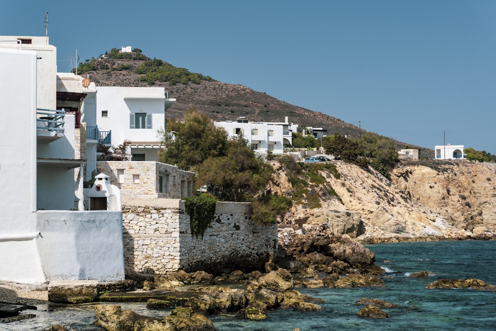 a white building on a cliff overlooking a body of water