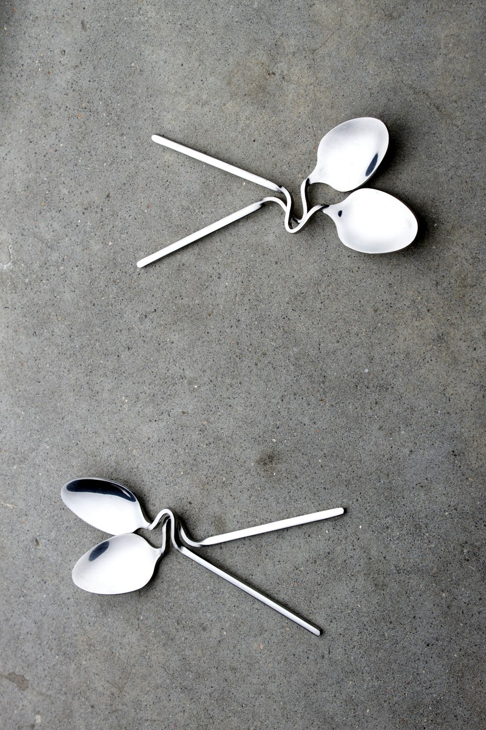 two grey stainless steel spoons