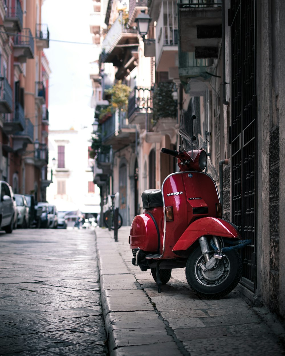 parked red motor scooter