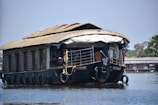 Spacious houseboat cabin overlooking tranquil backwaters at sunset.