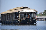 A vibrant houseboat floating on the tranquil backwaters of Kerala.