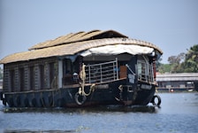 Spacious houseboat cabin overlooking tranquil backwaters at sunset.