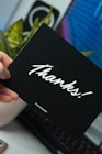 person holding thanks card