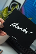 person holding thanks card