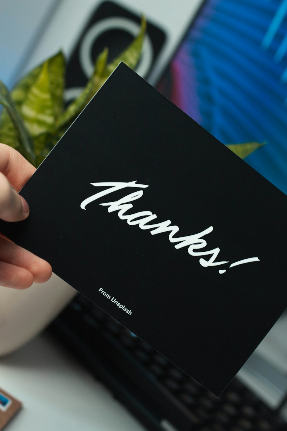 person holding thanks card