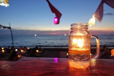 A summer candle with a beach and sun motif.