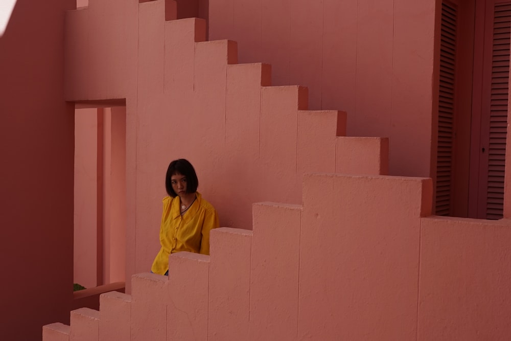 woman wearing yellow dress sitting on stair