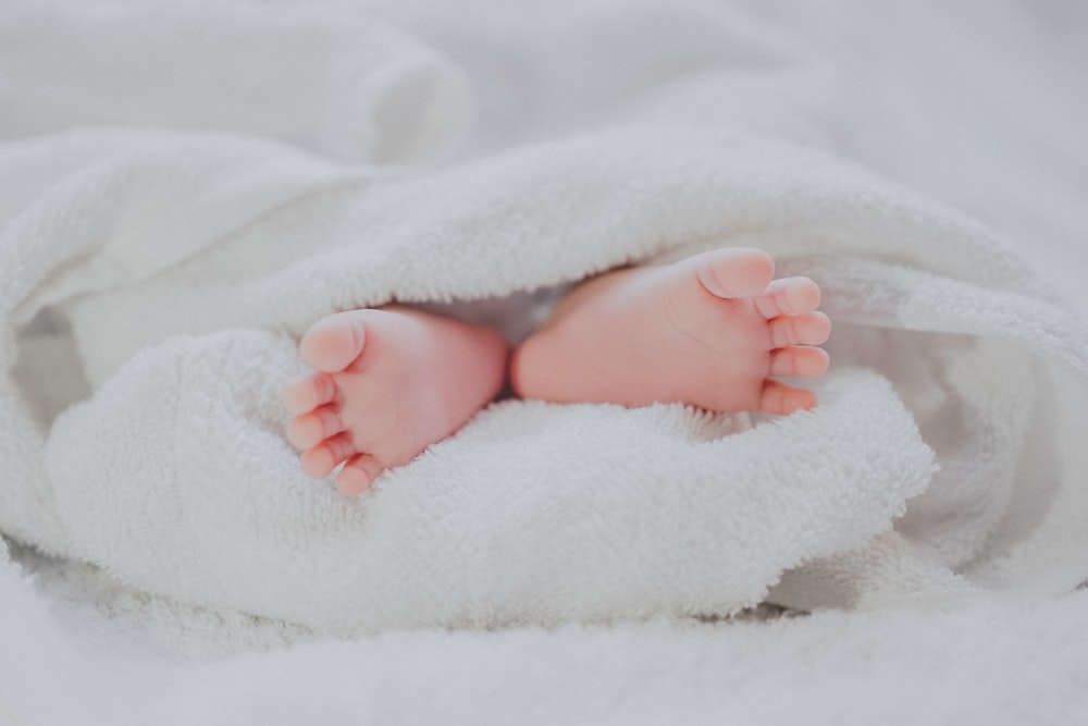 Baby feet in white blanket