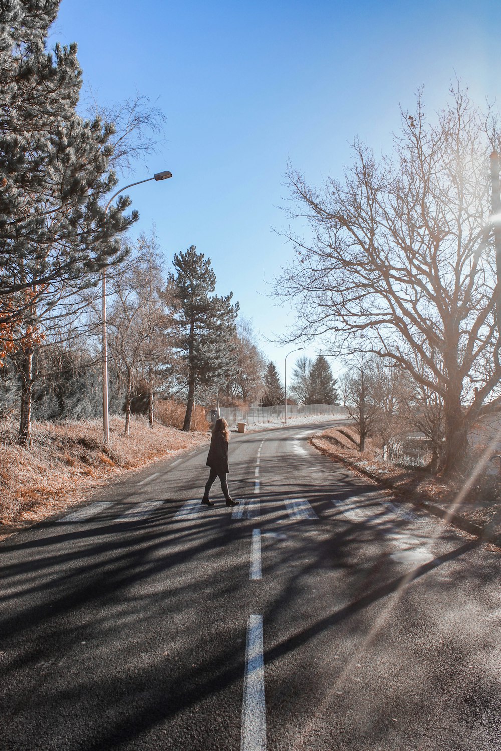 person standing in the middle of the road