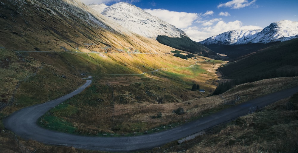 gray top road with rock mountain during day time