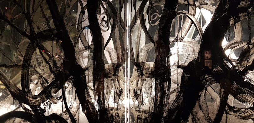 Decorative resin floor with intricate swirling patterns in black, white, and silver.