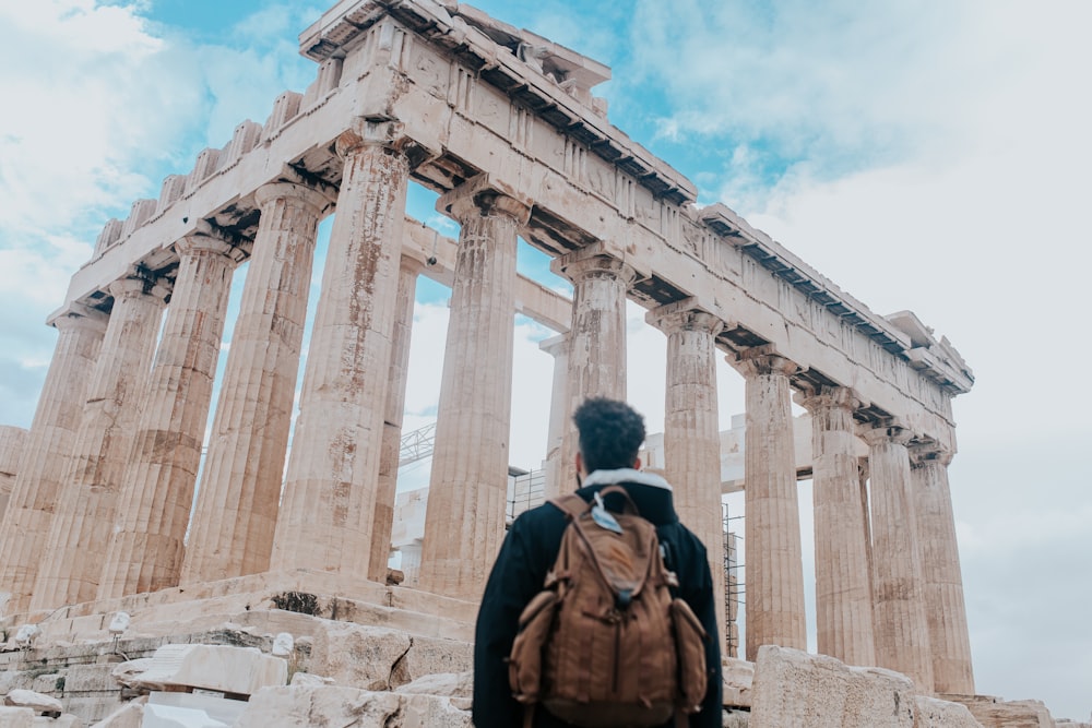 man standing near ruins during day time