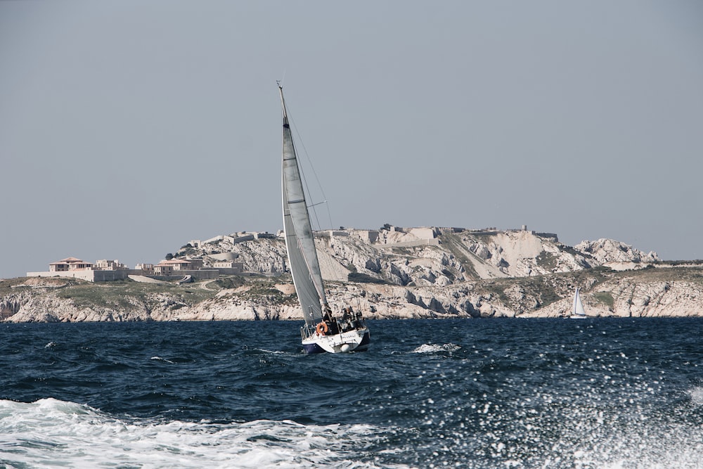 white sailboat on ocean