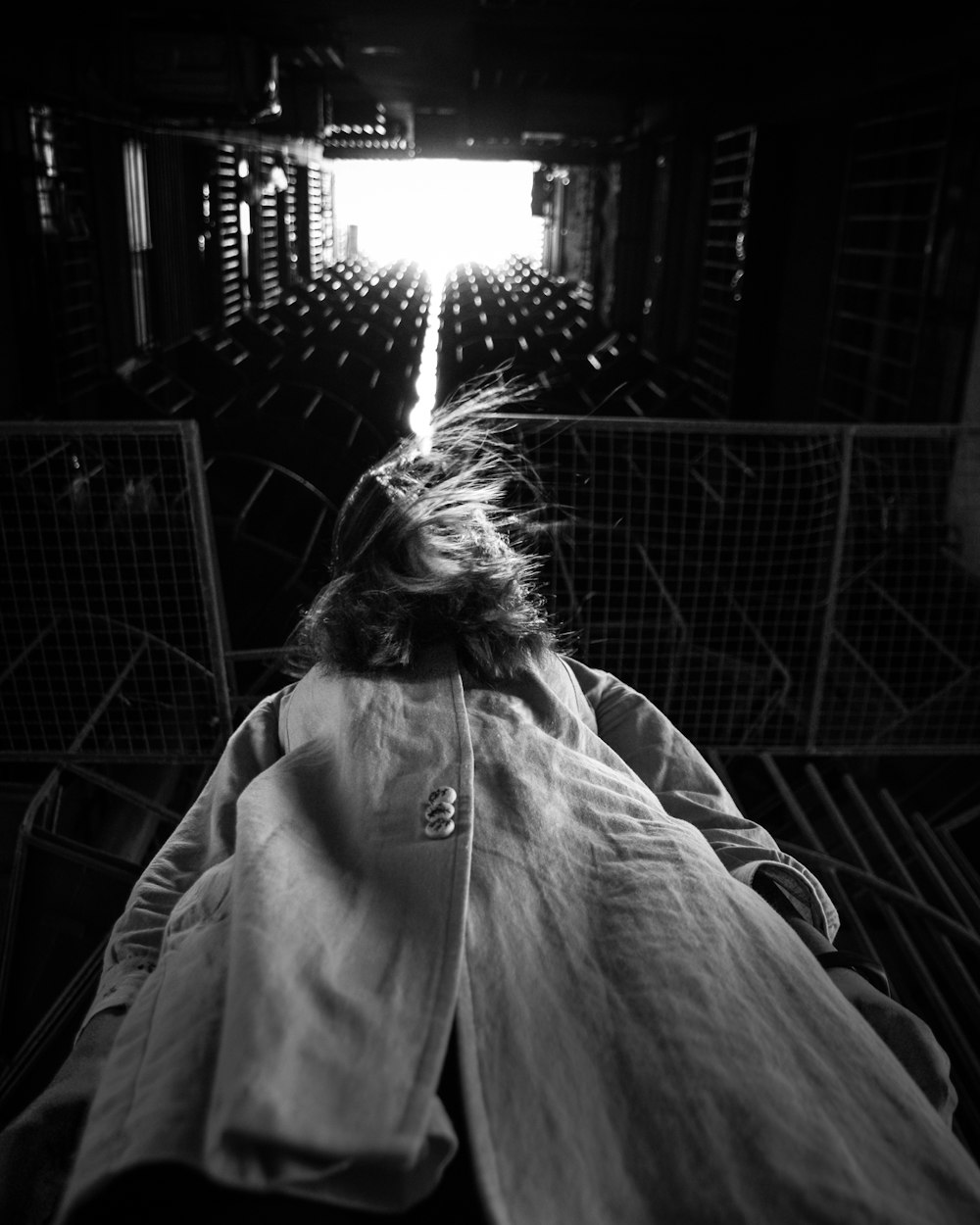 a woman laying in a bed in a dark room