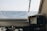 An engineer analyzing navigation systems on a modern ship in a controlled environment.