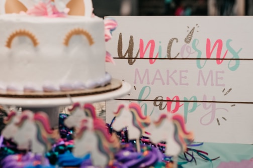selective focus photography of unicorns make me happy pallet signage