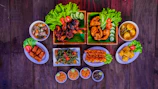 A colorful spread of Chinese favorites including noodles and crispy chicken lollipops.