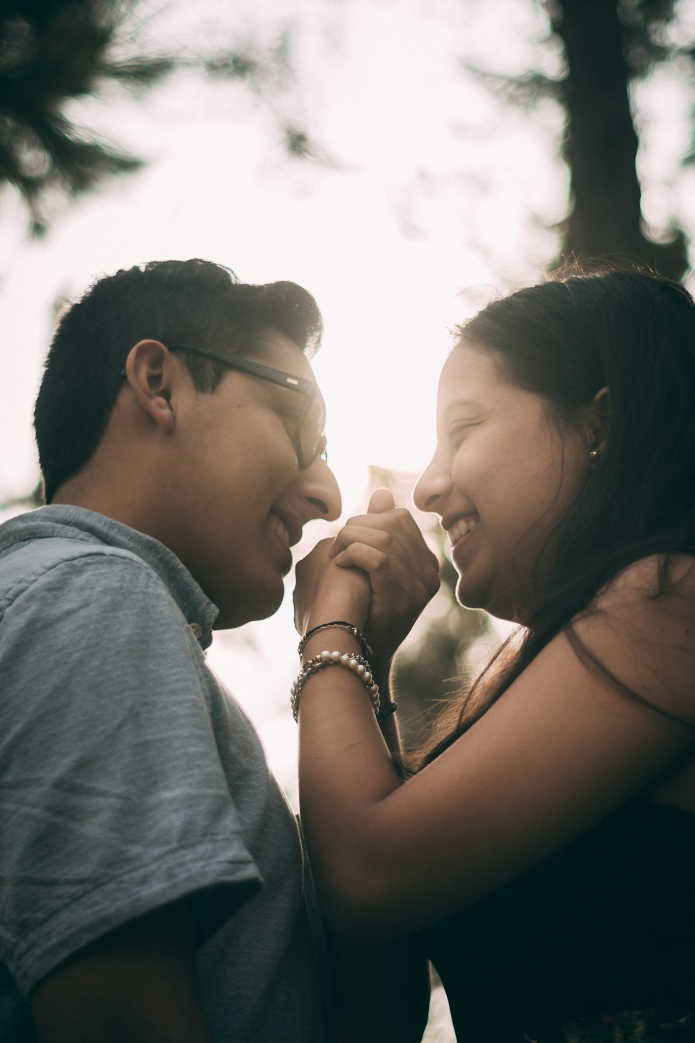 smiling woman and man facing each other