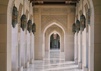 a hallway in a building with columns and arches