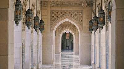 a hallway in a building with columns and arches