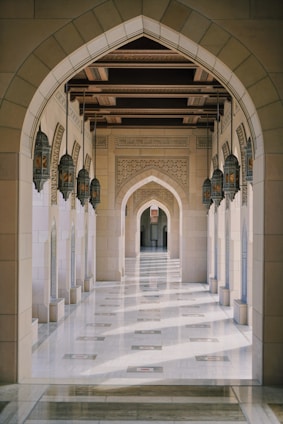 a hallway in a building with columns and arches