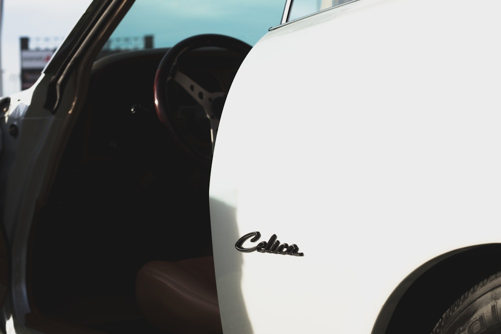 a close up of the door of a white car