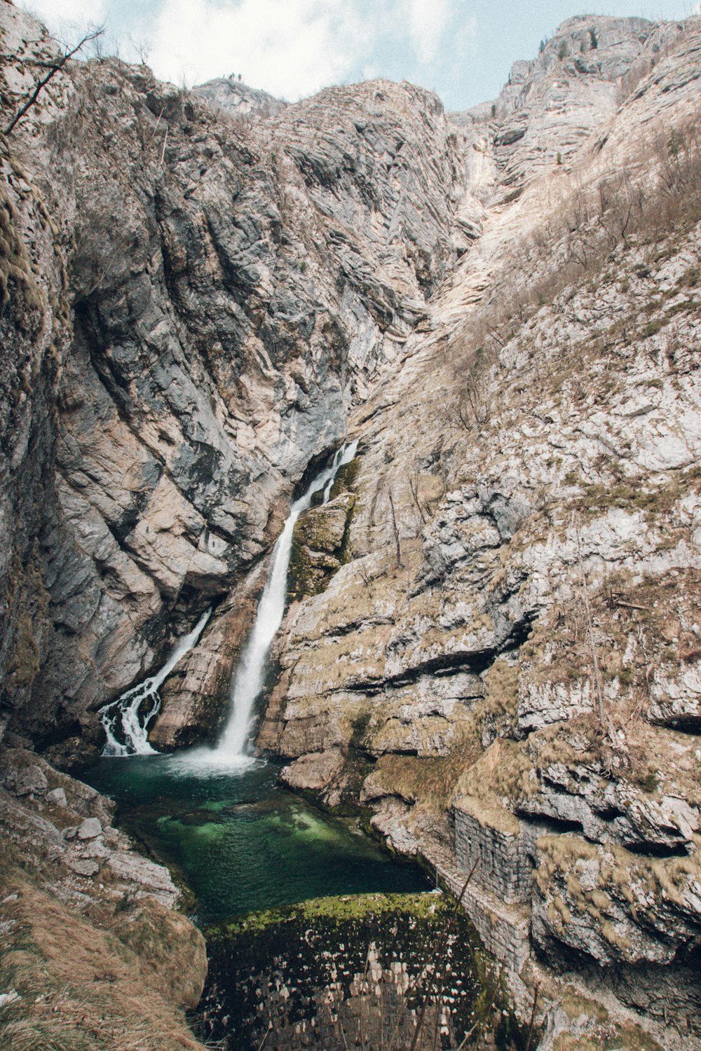 brown waterfalls surround of rocks