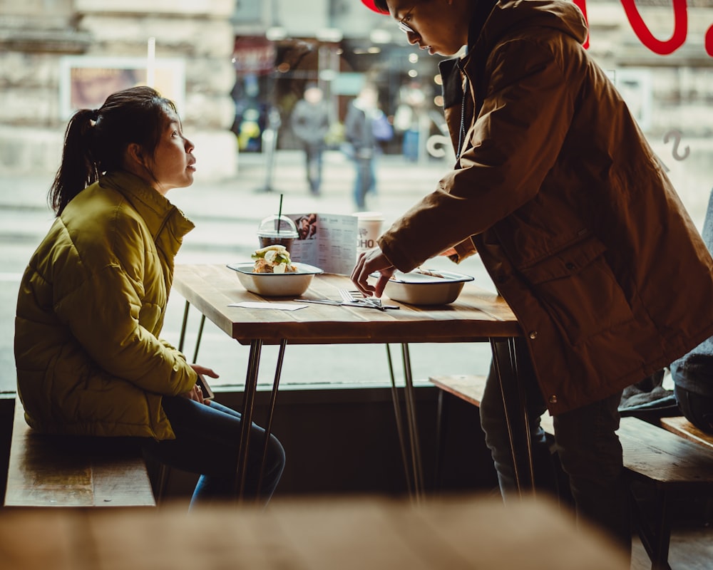 woman sitting in front of table