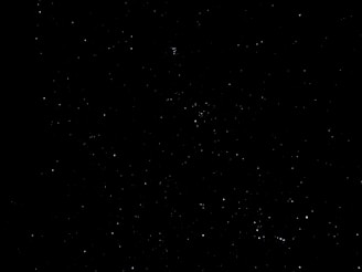 A densely populated night sky filled with numerous stars against a black backdrop, conveying a sense of vastness and mystery.
