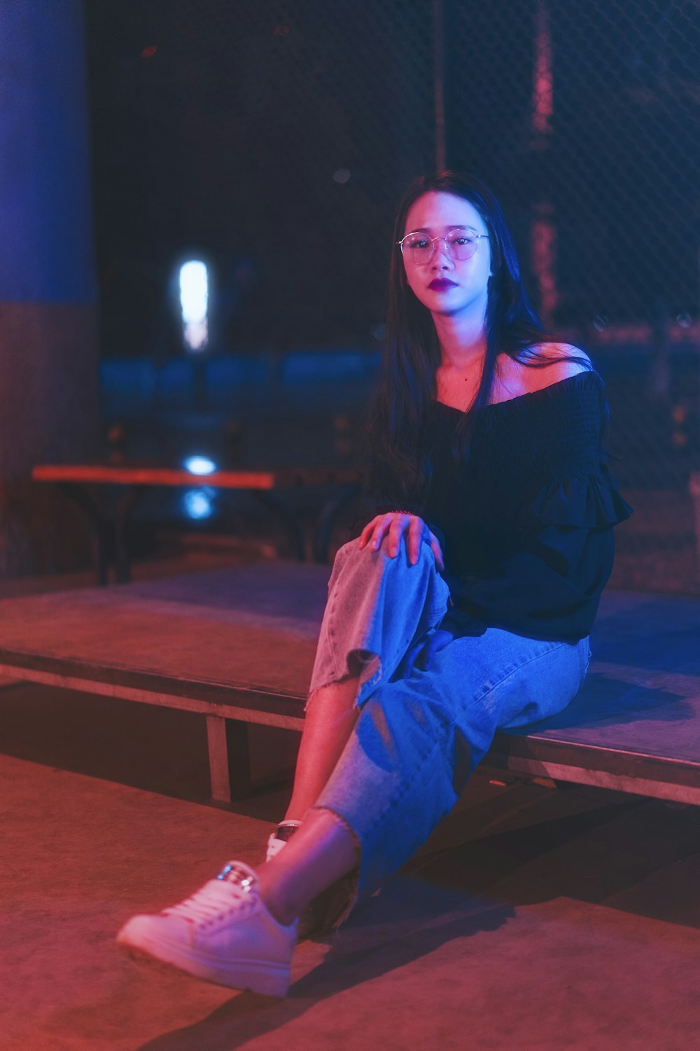 women sitting in wood during nighttime close-up photography