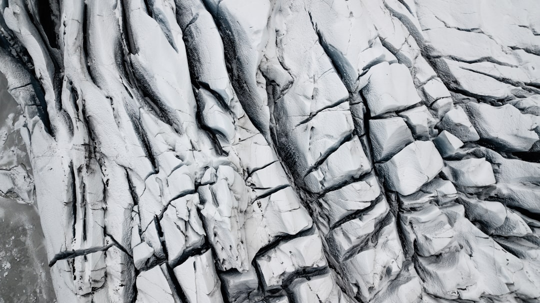 an aerial view of a glacier with ice and snow,