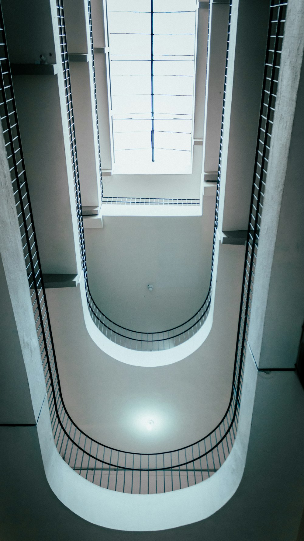 a spiral staircase in a building with a window