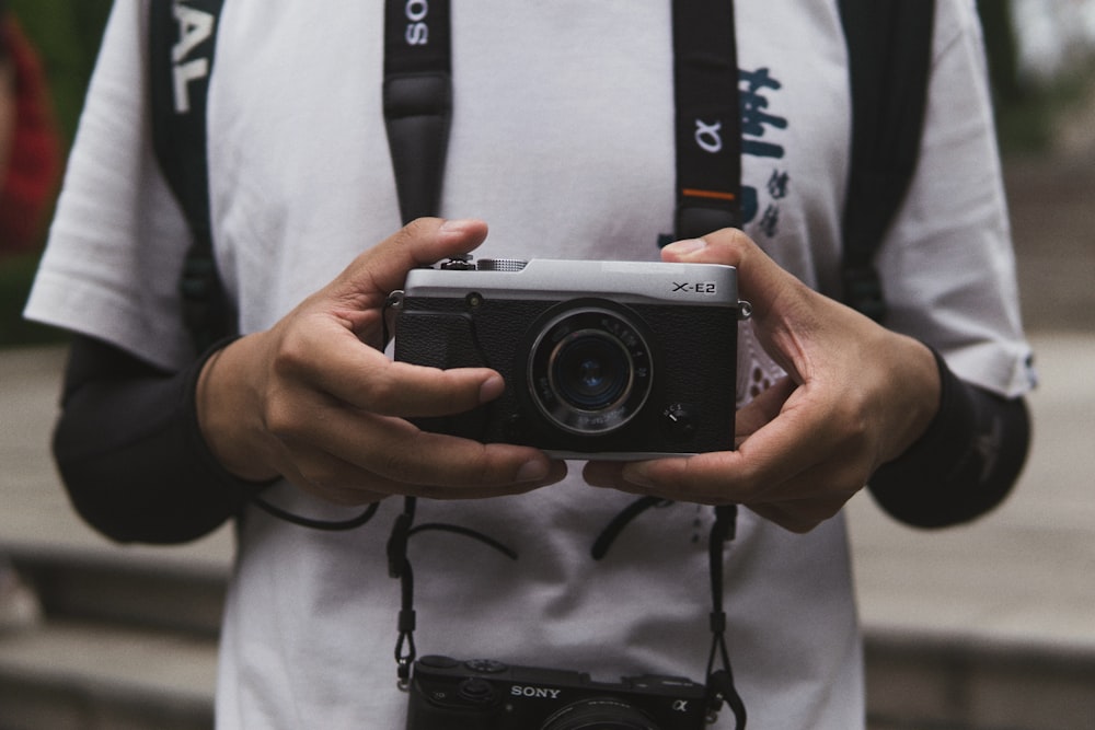 person holding black camera