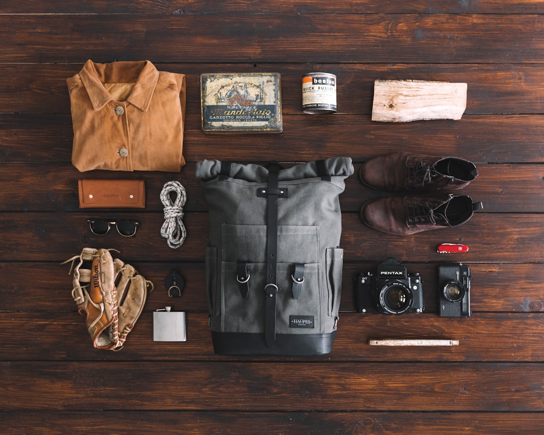 pair of brown leather boots, A flatlay view with our Ural backpack. Find out more on our website: haupes.com